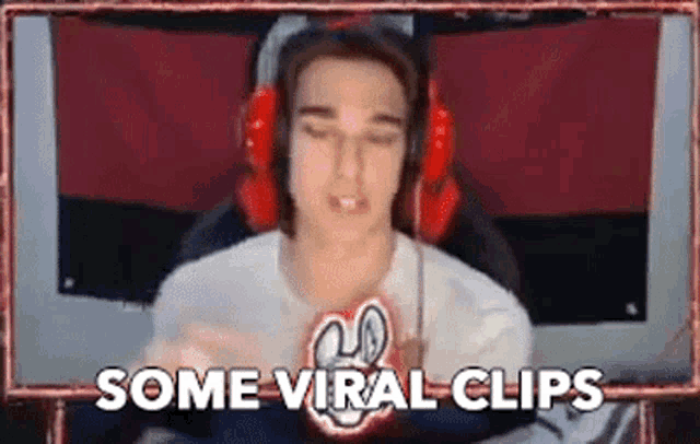 a man wearing headphones is sitting in front of a screen with the words `` some viral clips '' written above him .