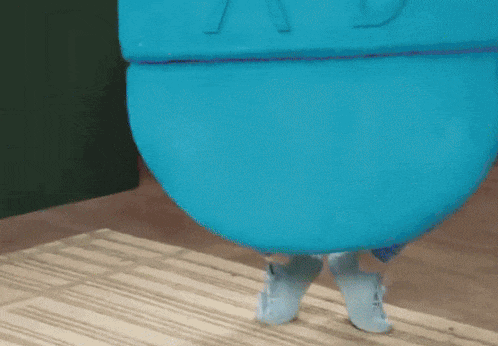 a person wearing a blue costume with the letter v on it