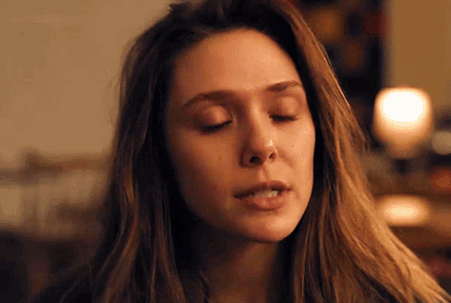 a woman with her eyes closed and her mouth open