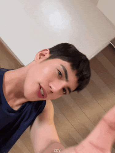 a young man taking a selfie with the letters zky visible