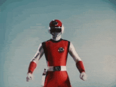 a man in a red suit and white gloves is holding a red sword