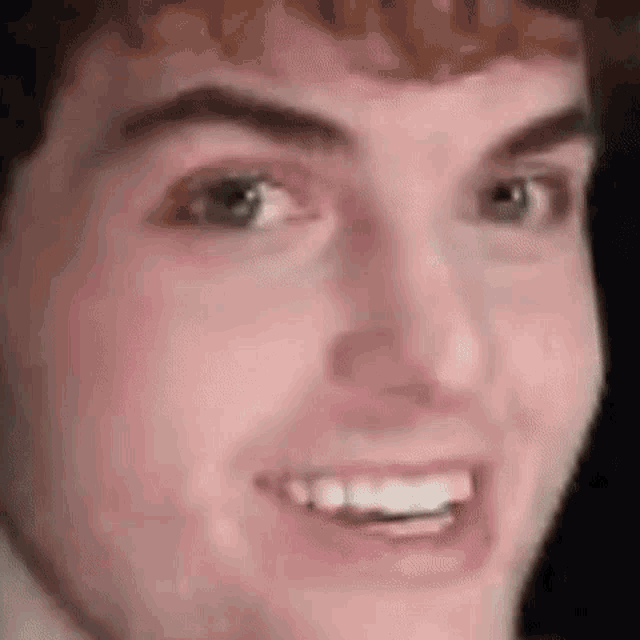 a close up of a person 's face with a smile on it .