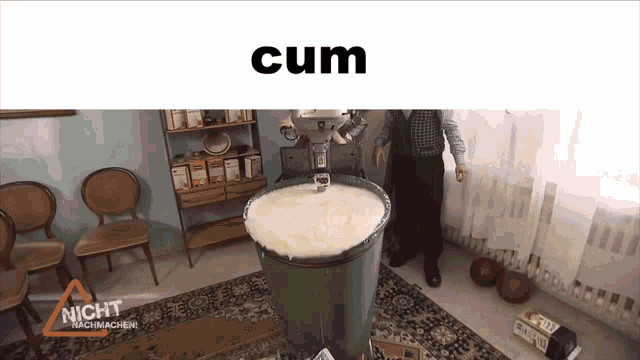 a man is standing in front of a large container that says cum