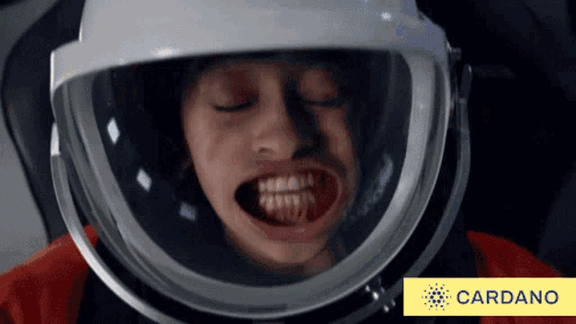 a person wearing a helmet with a cardano logo in the corner
