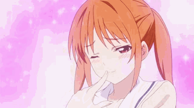 a girl is covering her nose with her hand .