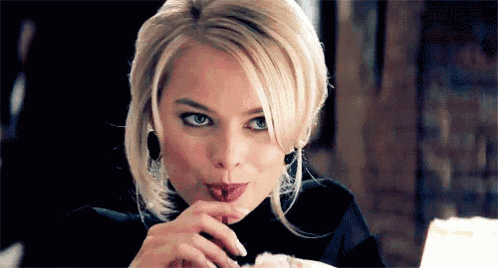 a close up of a woman licking her lips