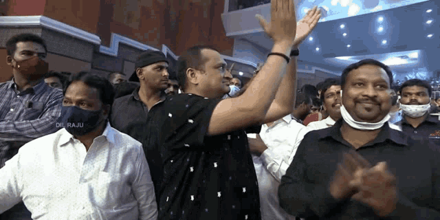 a man wearing a black shirt with the word raju on the front