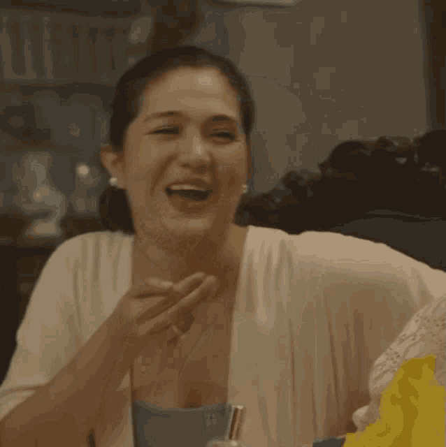 a woman with a surprised look on her face is sitting in a chair