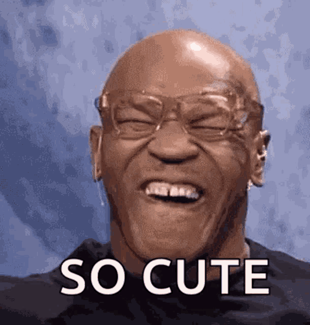 a bald man wearing glasses is laughing with the words `` so cute '' written next to him .