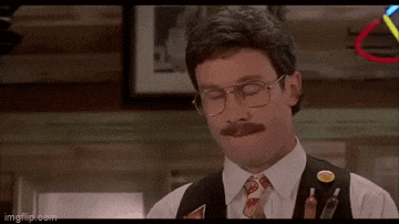 a man with glasses and a mustache is wearing a vest
