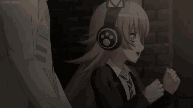 a girl wearing headphones is standing next to a man in a suit and tie .