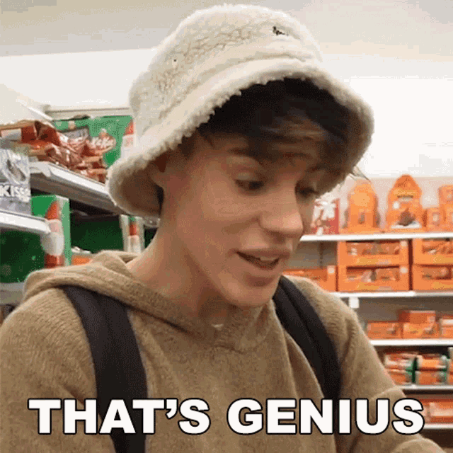a young man wearing a bucket hat and a hoodie says that 's genius