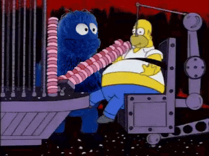 homer simpson is sitting in a chair holding a candy bar while cookie monster is holding a candy bar .