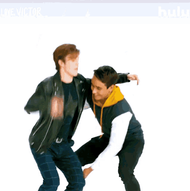 a man in a leather jacket is holding another man in his arms
