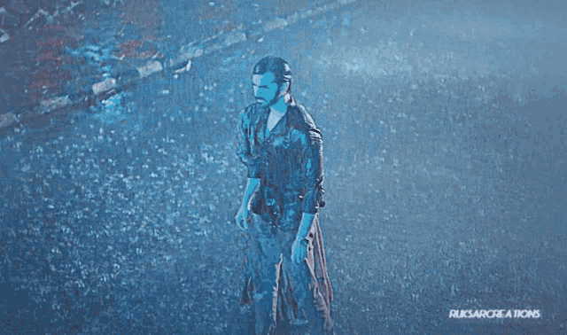 a man and a woman are standing in the rain with ruksarcreations written on the bottom