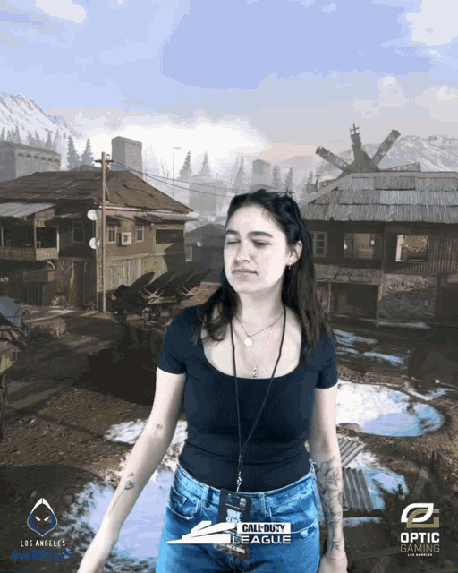 a woman is standing in front of a call of duty league background