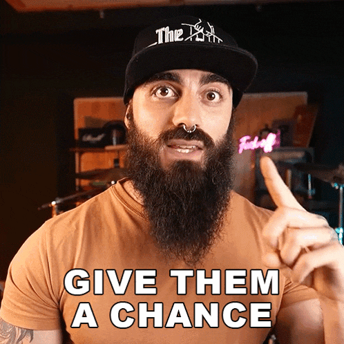 a man with a beard wears a hat that says the devil