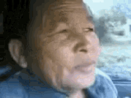 a close up of an elderly man 's face in a car .