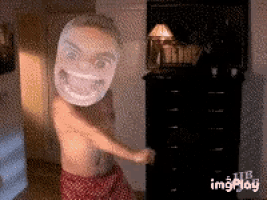 a shirtless person with a mask on their face dancing