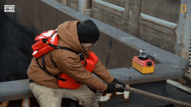 a man pulling a rope with breaking bobby bones written in the corner