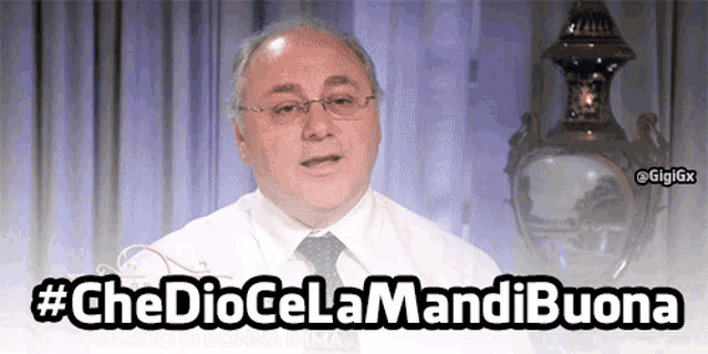 a man in a white shirt and tie with the words che dio cela mandi buona