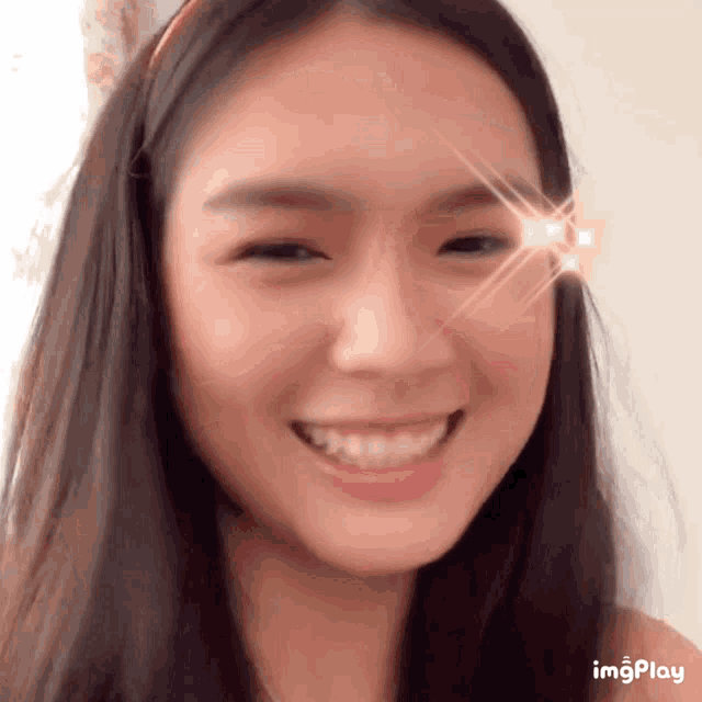 a close up of a woman 's face with the word imgplay on the bottom right