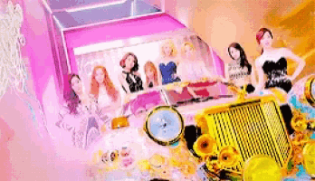 a group of dolls are sitting in a pink and yellow car