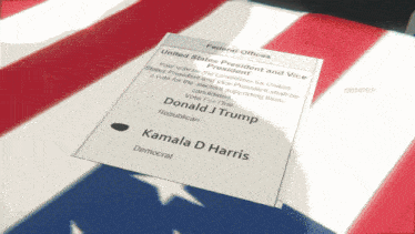 a ballot for kamala harris sits on a flag