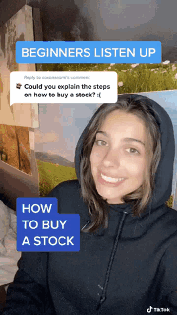a woman in a black hoodie is smiling in front of a wall with paintings and says beginners listen up