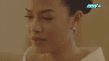 a close up of a woman 's face with her eyes closed and a pptv logo in the background .