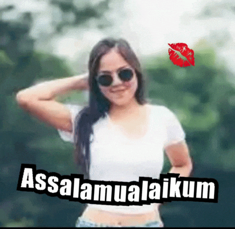 a woman wearing sunglasses and a white shirt with the words assalamualaikum