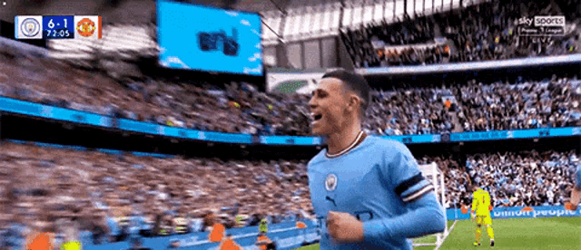 a soccer player celebrates a goal in front of a crowd