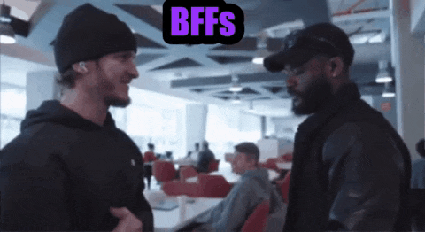 two men are having a conversation with a sign that says bffs on it