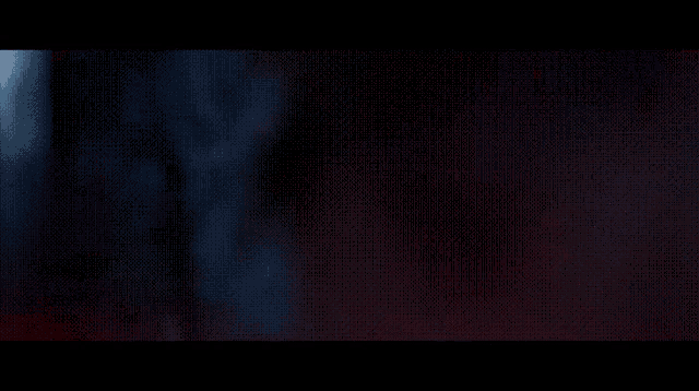 a close up of a person 's face with a red light coming out of it