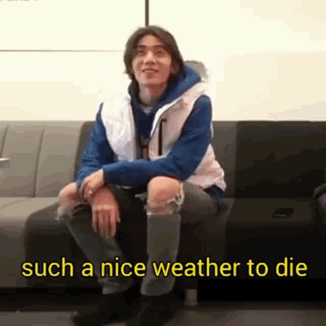 a man is sitting on a couch with the words `` such a nice weather to die '' written on the bottom .