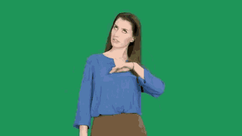 the woman is wearing a blue shirt and brown pants and her hair is blowing in the wind
