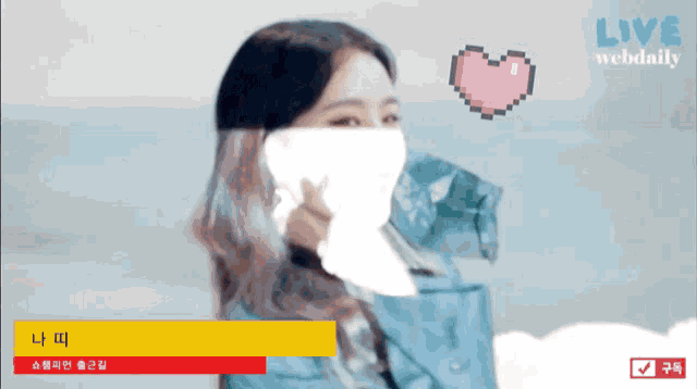 a woman wearing a face mask is on a live webshow