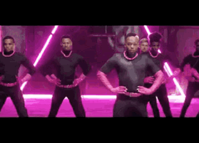 a group of men are standing next to each other in a dance studio .