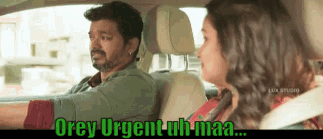 a man and a woman are sitting in a car and the man is driving .