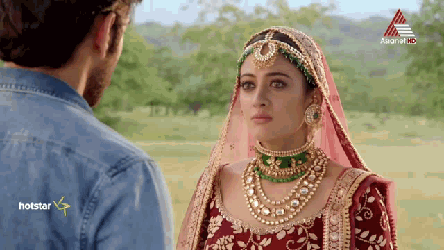 a man and a woman are looking at each other with asianet hd written on the bottom