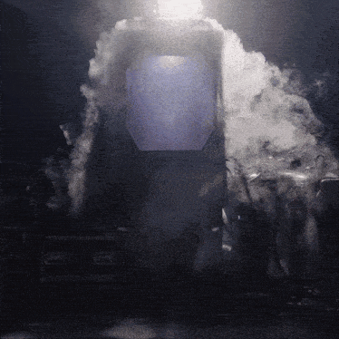 a dark room with smoke coming out of a box that says ' a ' on the side