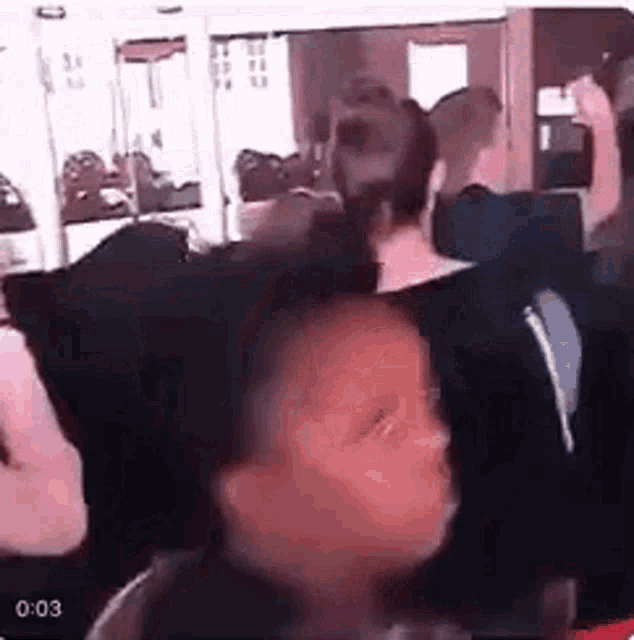 a group of people are sitting on a bus and a little girl is sitting in the middle of the bus .
