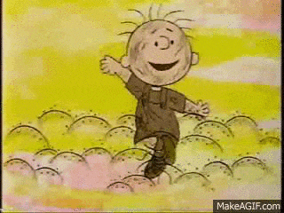 a cartoon character from the peanuts movie is standing in a field and smiling .