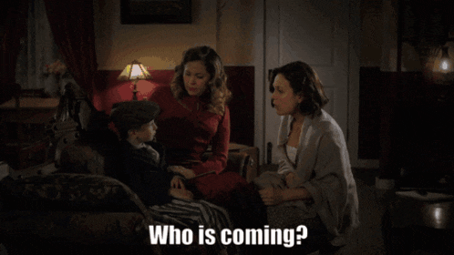 two women and a child are sitting on a couch with the words who is coming below them