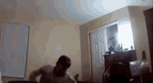 a man is sitting on a couch in a living room .
