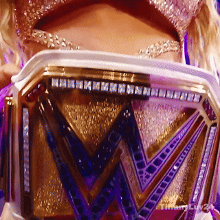 a close up of a woman holding a w belt