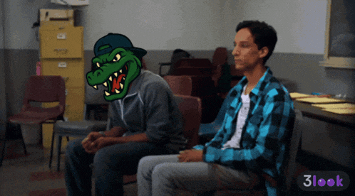 a man in a plaid shirt sits next to another man with a crocodile on his face
