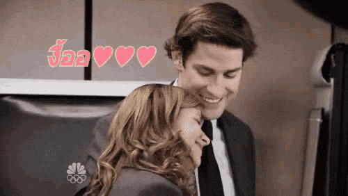 a man in a suit and tie is hugging a woman in a suit and tie .