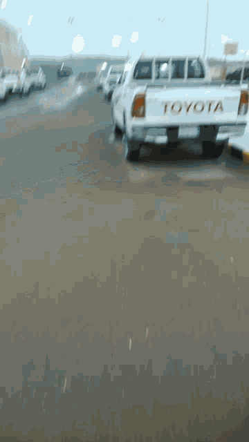 a toyota truck is driving down a road