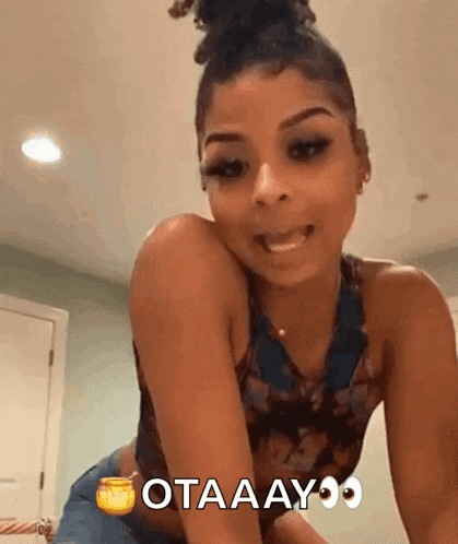 a woman is kneeling down with the words otaaayo written on the bottom